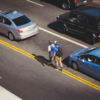 people and cars on the road