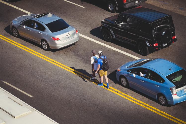 people and cars on the road