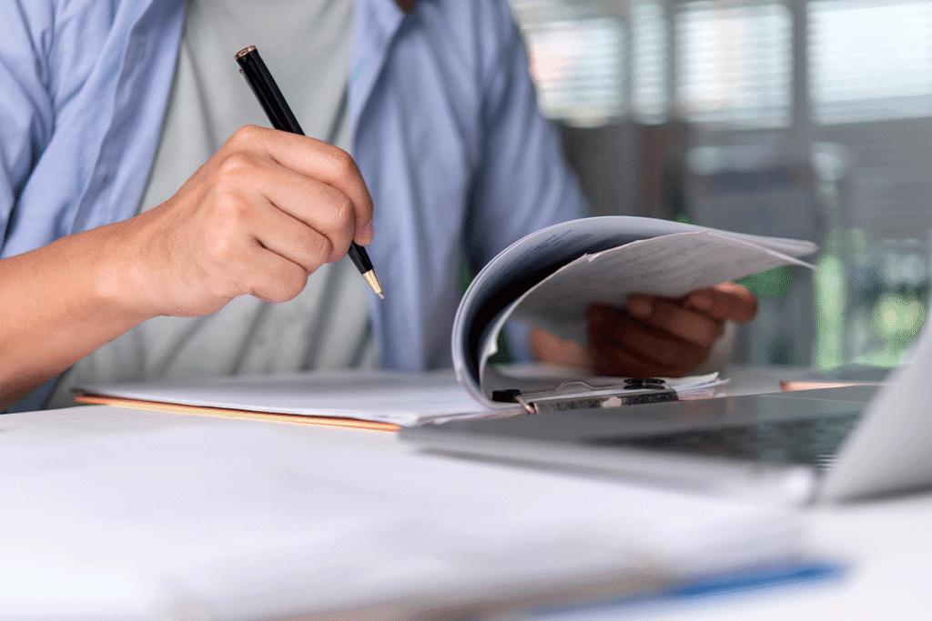Medical examiner reviewing medical records during an IME