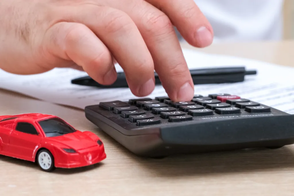 Calculator and model car representing how diminished value is calculated after an accident