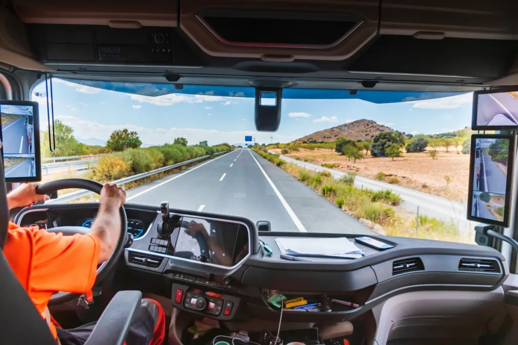 Commercial truck driver driving along a highway in daylight