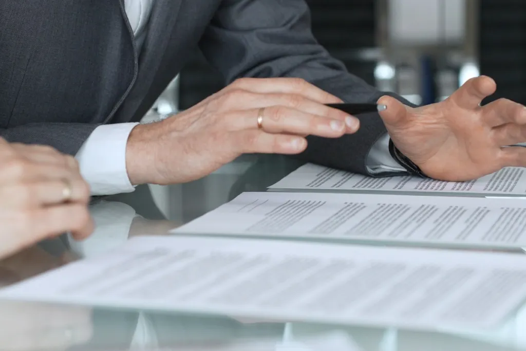 People reviewing paperwork at a desk, illustrating an e-bike accident claim review