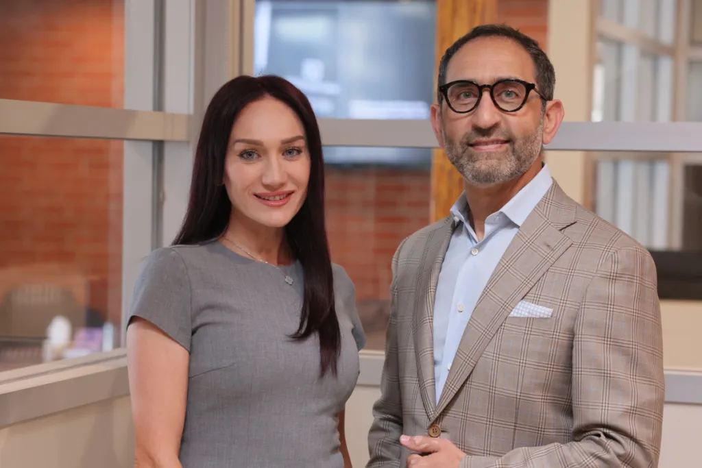Two Yepremyan Law Firm team members standing together at their office